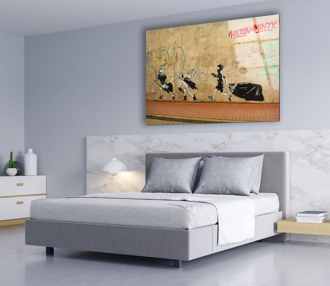 a bedroom with a bed and a painting on the wall