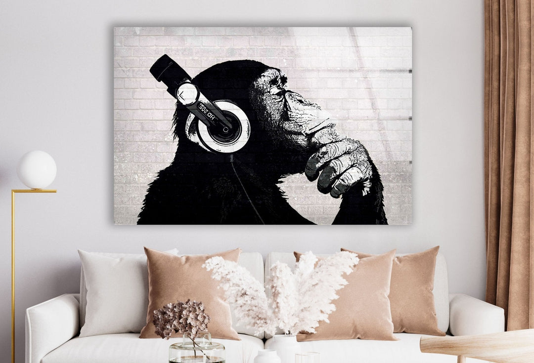 a picture of a monkey with headphones hanging on a wall