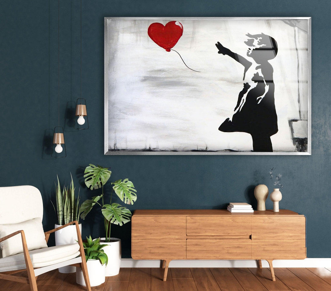 a living room with a painting of a woman holding a heart balloon