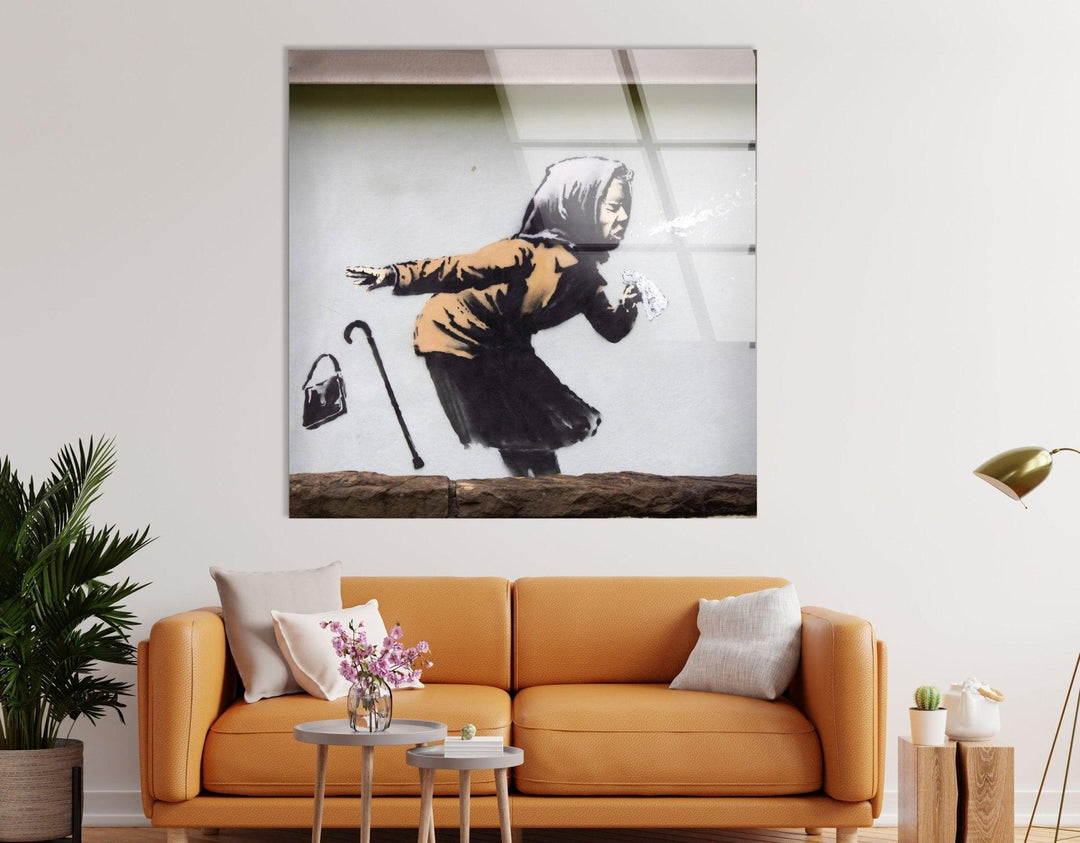 Banksy Sneezing Woman Glass Wall Art - Our Banksy art for sale includes a variety of pieces, from famous works to unique interpretations, all meticulously printed on reinforced tempered glass. This medium not only enhances the vivid colors and intricate details of Banksy's work but also ensures durability and longevity. Ideal for both indoor and outdoor use, these pieces are versatile and built to last.