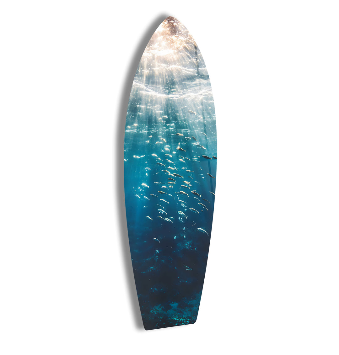 Stunning underwater surfboard wall art featuring sunlight rays and a school of fish.
