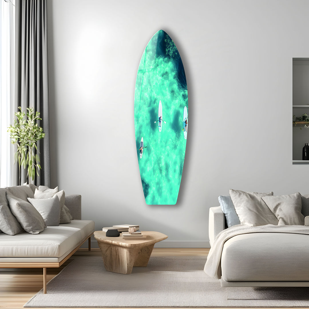 Paddleboarders in Paradise: Coastal glass wall art depicting serene paddleboarding moments on clear blue waters.
