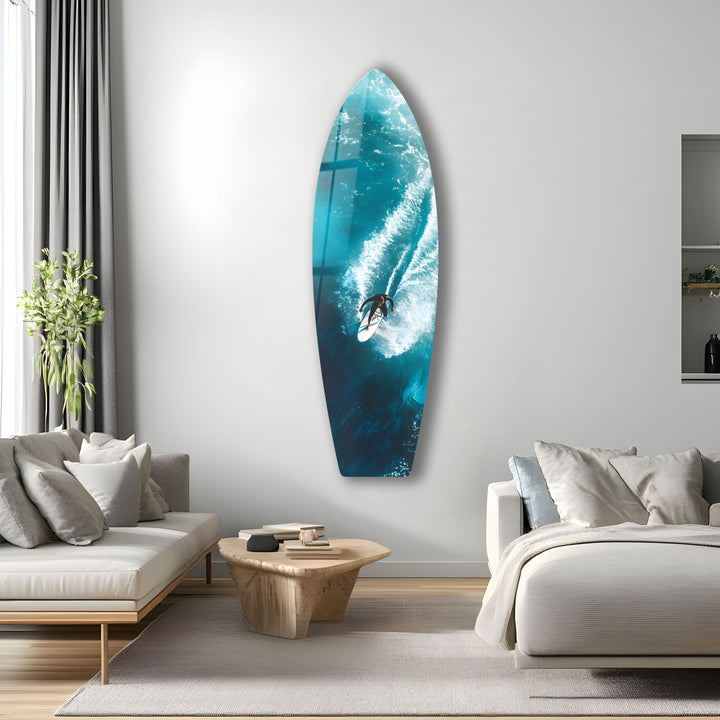 Exciting wave-riding scene on a surfboard-shaped glass wall art, bringing the ocean to your home.
