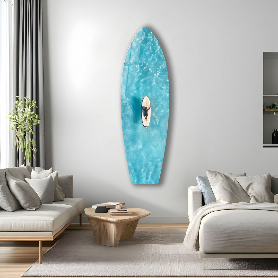 Clear blue waters and a surfer in perfect harmony, captured from above and printed on glass.
