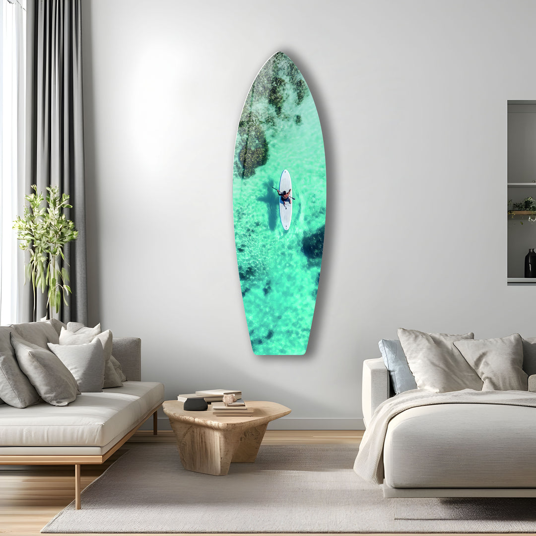 Paddleboarder riding calm, clear waters in this stunning aerial view, bringing the peace of the ocean to your walls.
