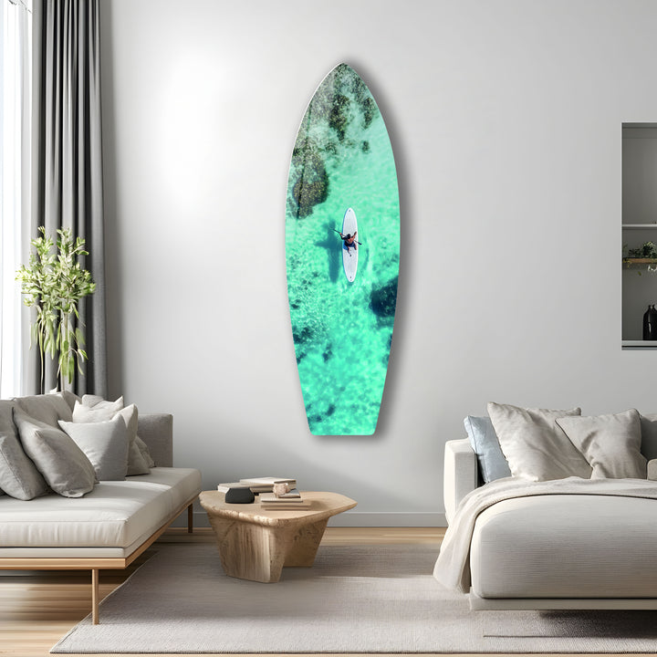 Paddleboarder riding calm, clear waters in this stunning aerial view, bringing the peace of the ocean to your walls.
