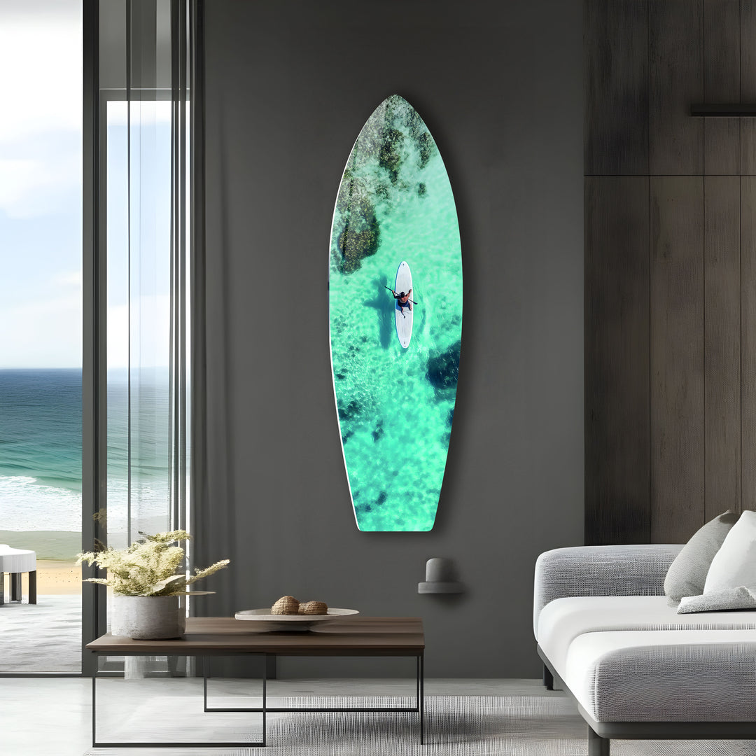 A breathtaking ocean scene with a lone paddleboarder, captured from above on high-quality glass.
