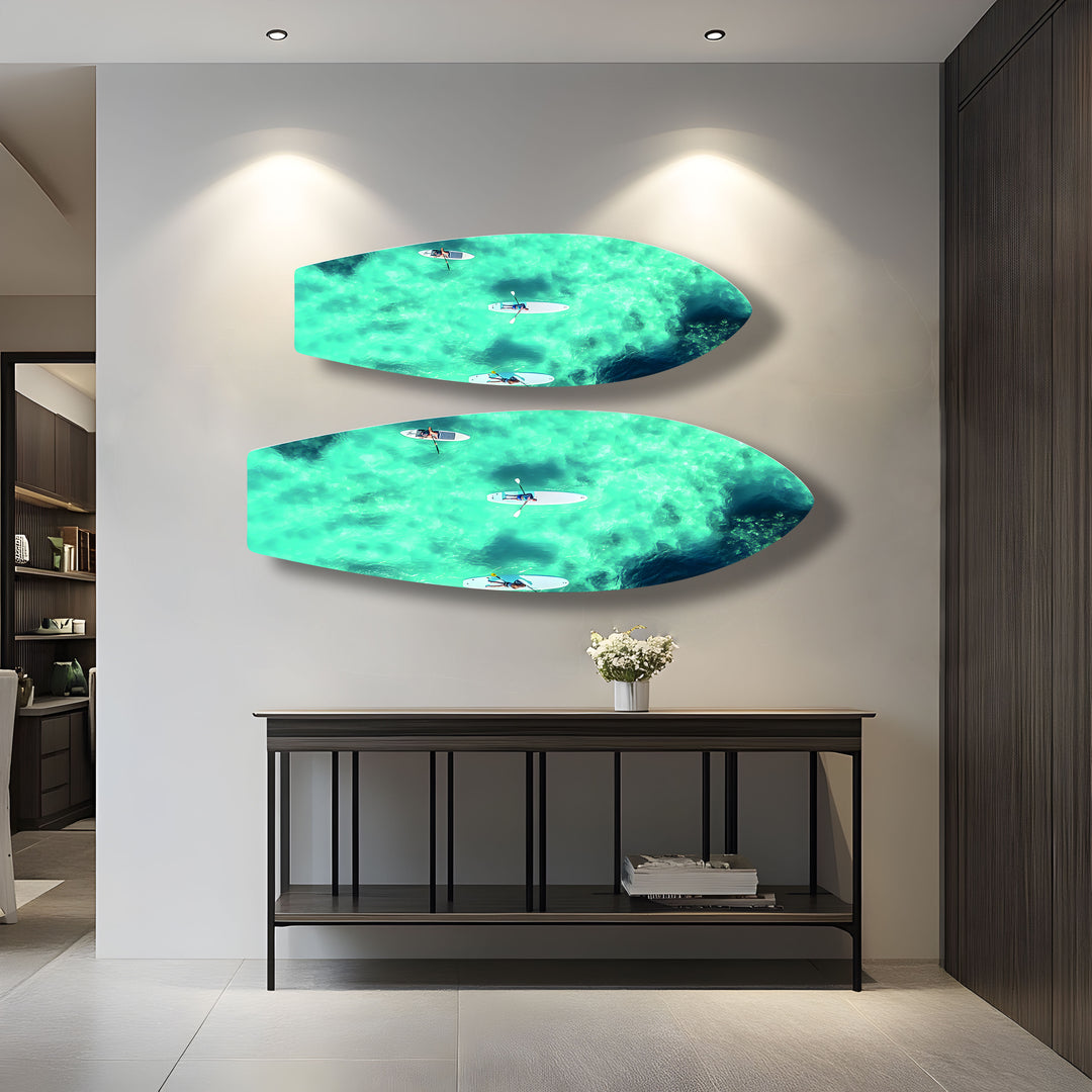 Ocean Serenity on Glass: Paddleboarders floating through crystal-clear waters captured in stunning glass wall art.
