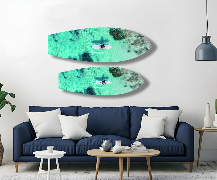 Vivid aerial ocean view with a paddleboarder, creating a serene and refreshing atmosphere for any room.
