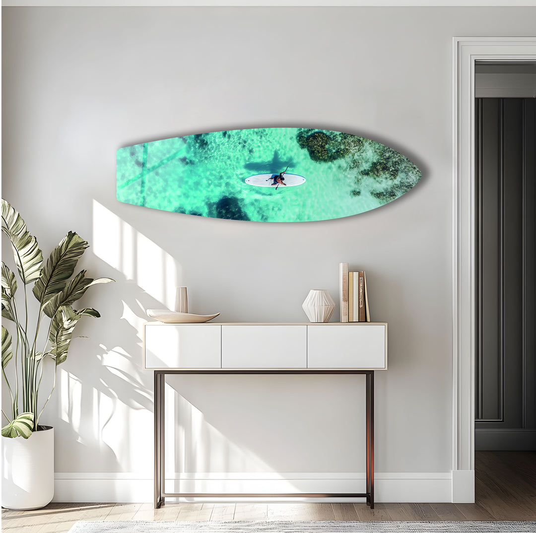 Vibrant aerial view of a paddleboarder surrounded by turquoise waters, adding coastal beauty to your home.
