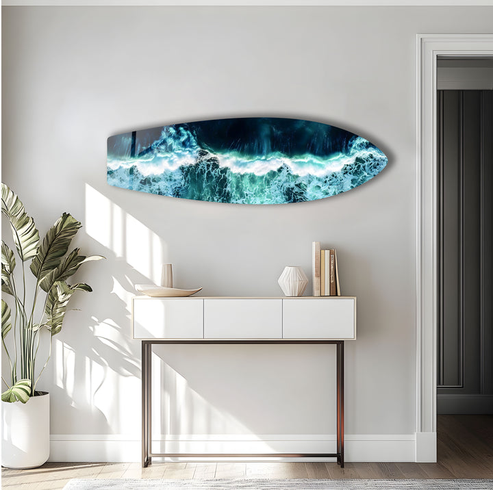 Dynamic ocean scene with white-tipped waves crashing onto the shore, captured on glass.
