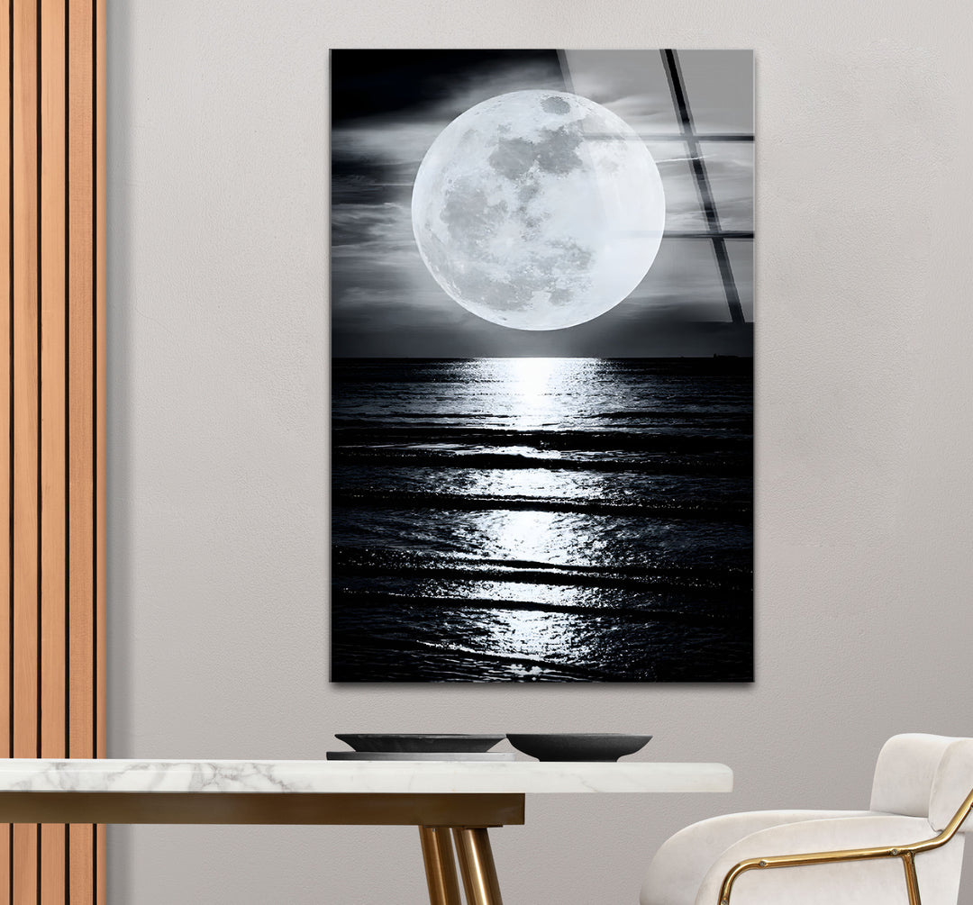 Modern black and white framed art capturing the beauty of a full moon illuminating the ocean.