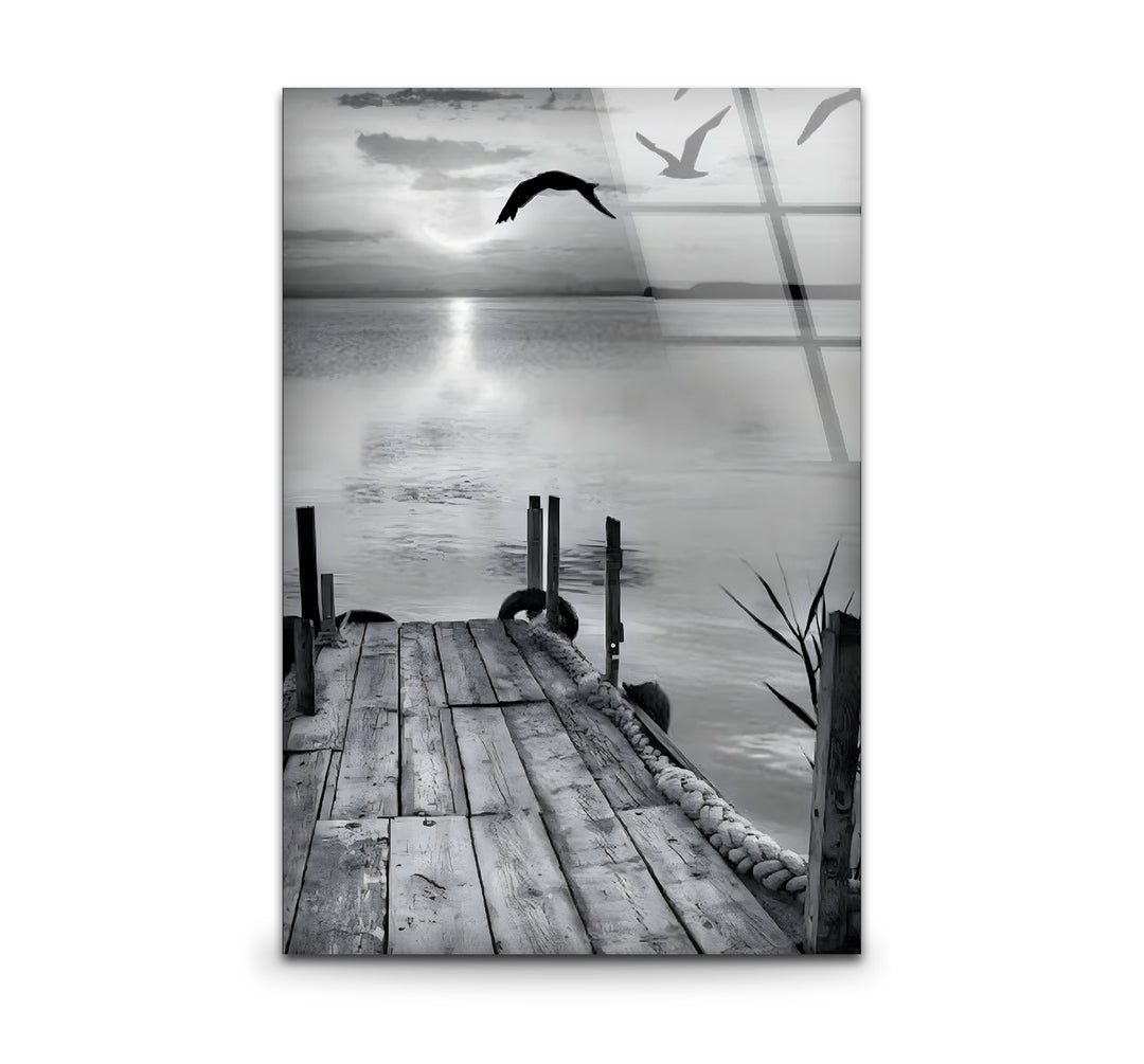 Serene black and white wall art featuring a dock stretching into a tranquil lake under a moody sky.