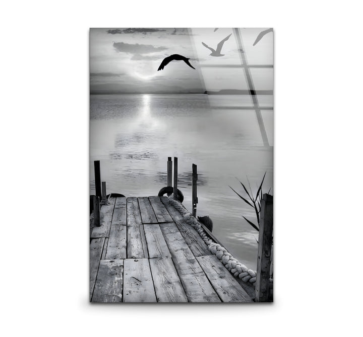 Serene black and white wall art featuring a dock stretching into a tranquil lake under a moody sky.