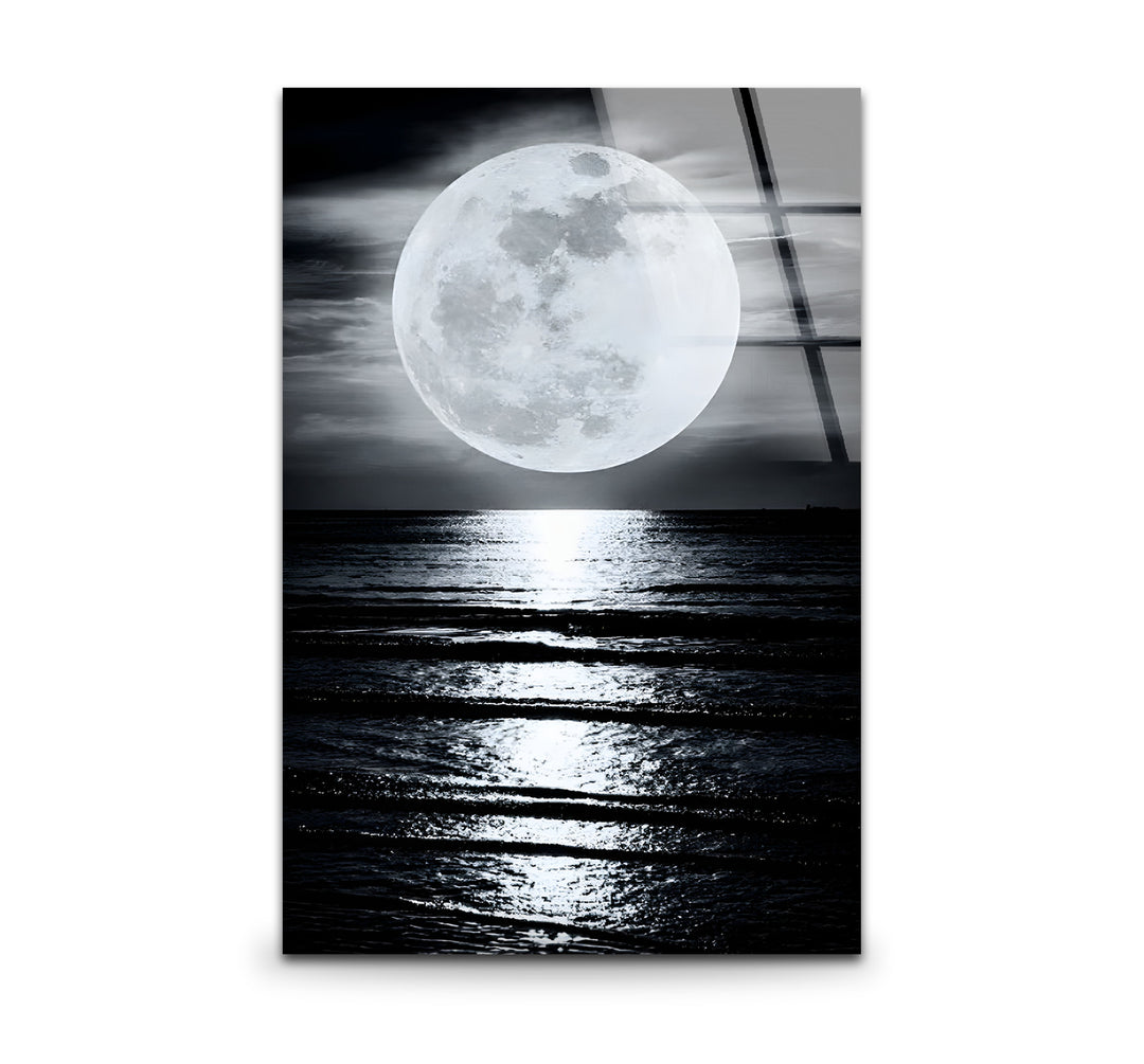 Elegant black and white wall art featuring a glowing moon over a tranquil ocean landscape.