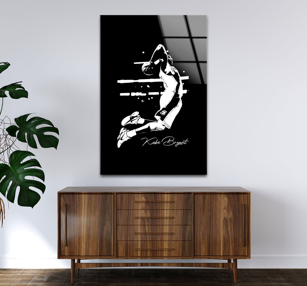 Stylish black and white artwork showcasing Kobe Bryant's iconic basketball pose in silhouette form.