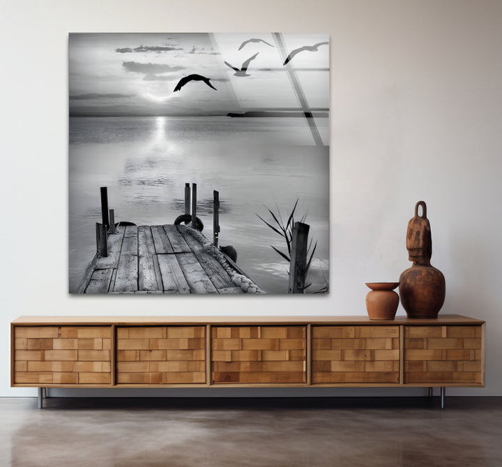 Sophisticated black and white framed art of a dock extending into a misty horizon.