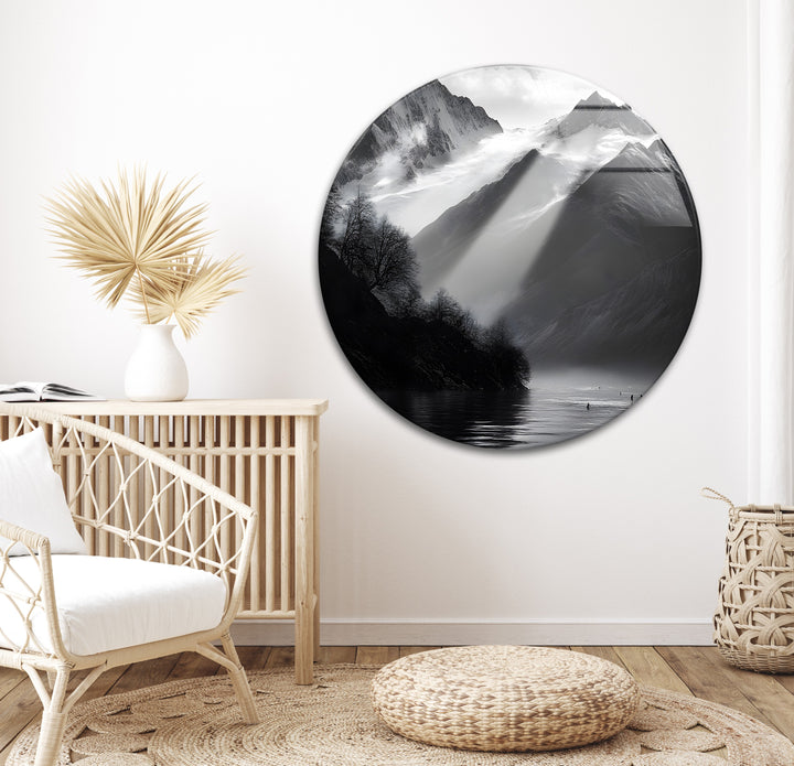 Breathtaking black-and-white mountain landscape with sunlight beams, displayed on glass.
