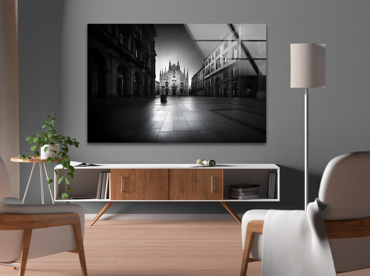 A dramatic black and white cityscape highlighting the intricate details of the Duomo di Milano.
