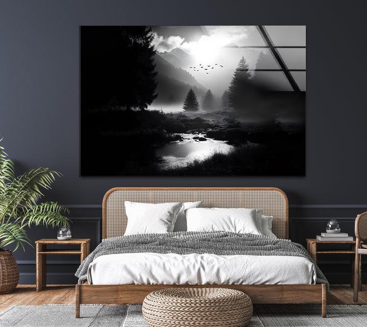 A peaceful mountain scene with glowing light and misty trees, beautifully detailed in black and white glass wall art.
