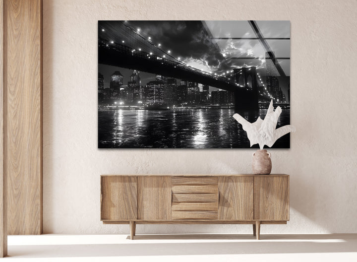 A stunning monochrome glass wall art piece showcasing the Brooklyn Bridge stretching across the water.
