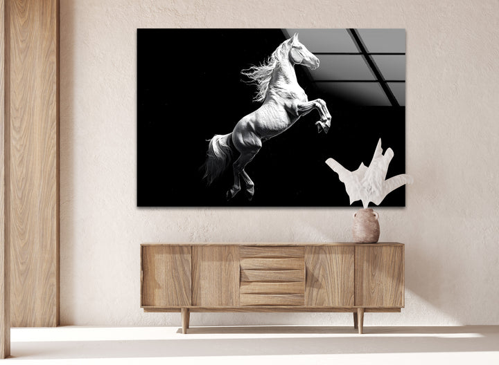 Black and white glass wall art capturing the strength and beauty of a rearing white horse.