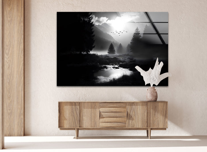 Elegant black and white glass wall art of a tranquil mountain river, surrounded by a dense pine forest.
