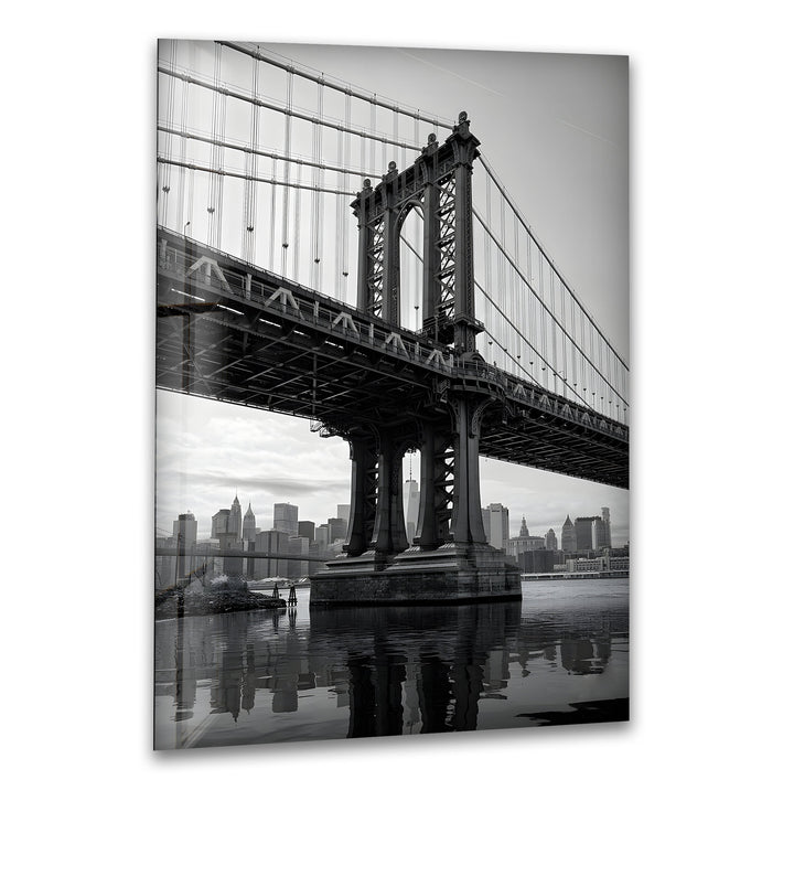 Black and white Manhattan Bridge glass wall art with NYC skyline reflection.
