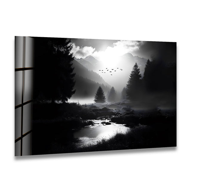 A breathtaking black and white glass wall art featuring misty mountains and a serene forest landscape.
