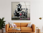 a living room with a couch and a painting on the wall - Artdesigna Glass Printing Wall Arts - Large Banksy Wall Art