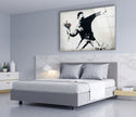 a bedroom with a bed and a painting on the wall