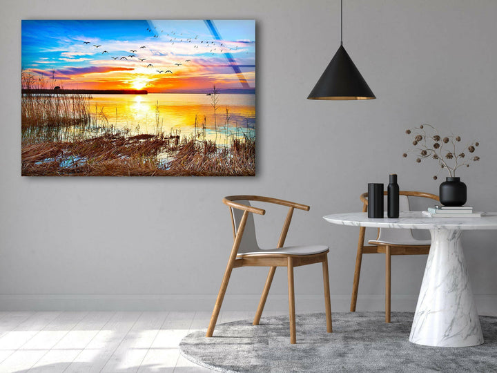 Sunset Over a Lake With Grass Glass Wall Art