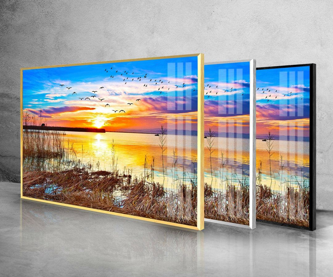 Sunset Over a Lake With Grass Glass Wall Art