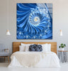 a bed with a white comforter and a blue painting on the wall