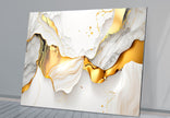 a white and gold abstract painting on a wall