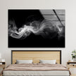 a picture of smoke on a wall above a bed