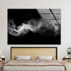 a picture of smoke on a wall above a bed